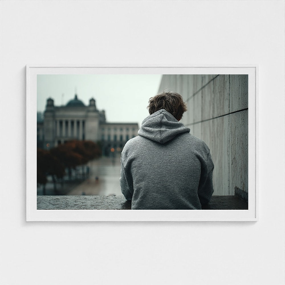 Contemplative Hooded Figure in Urban Concrete Plaza