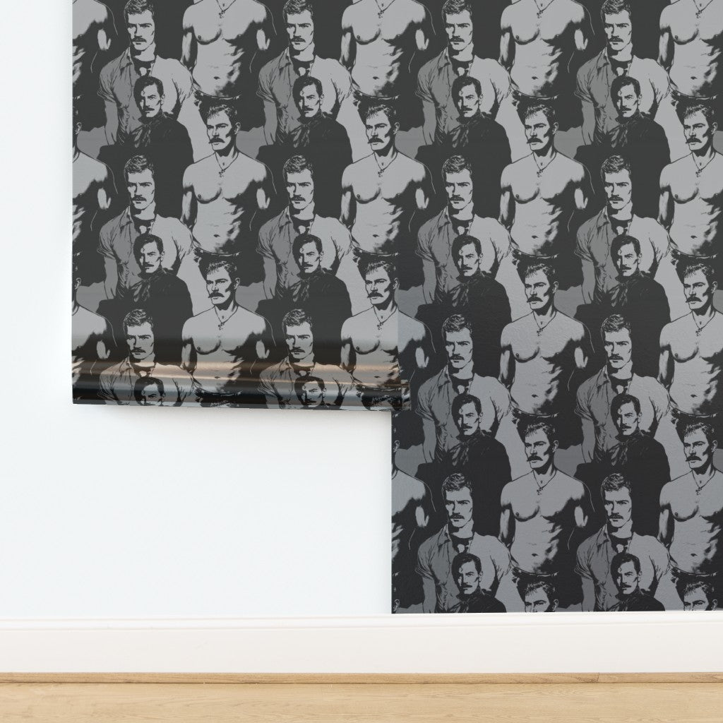 Top-down view of rolled black and white statement wallpaper with portrait graphics