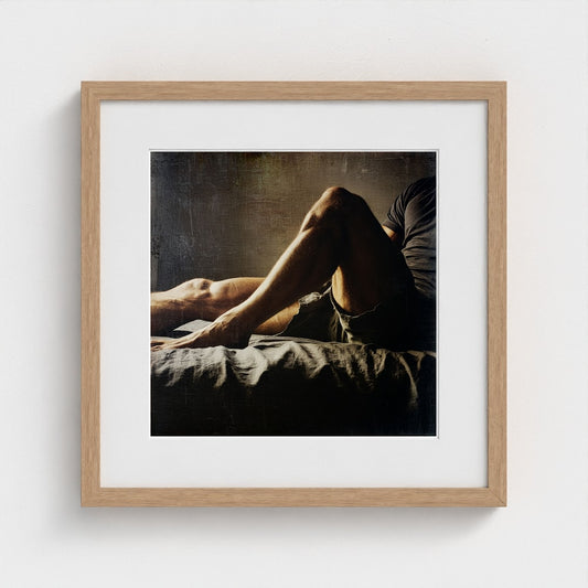 Male Legs on Crumpled Bed in Quiet Earth Tones