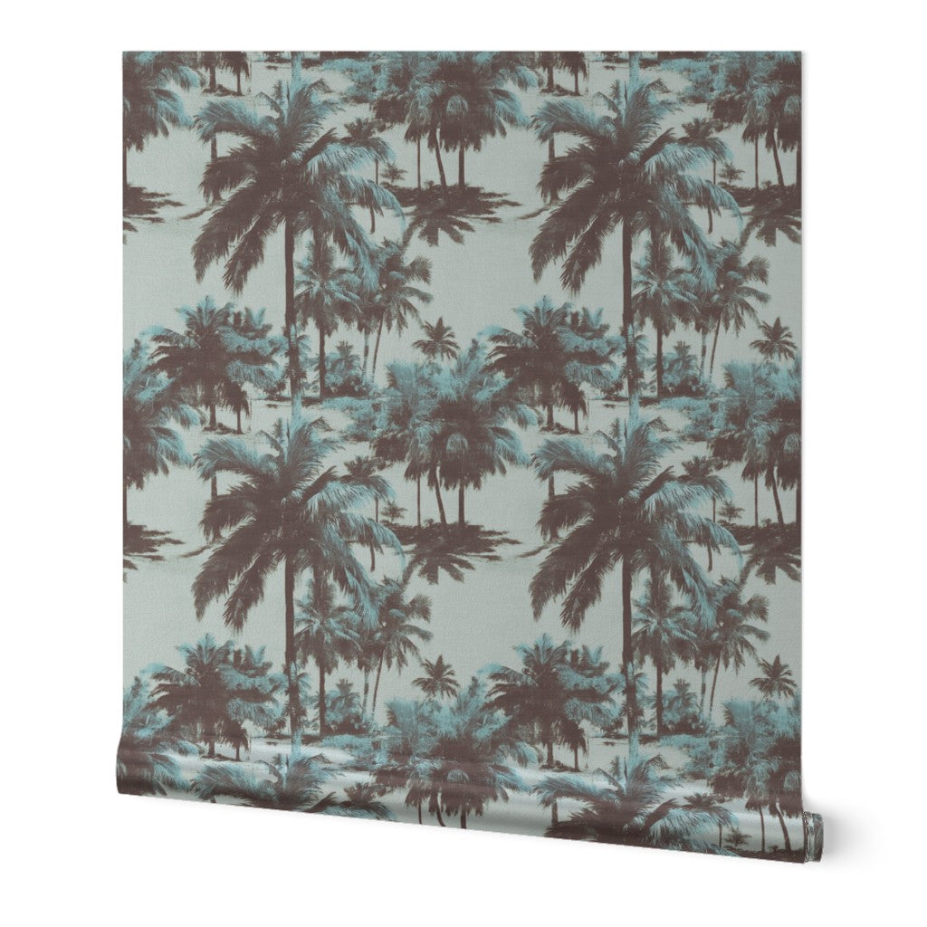 Roll of pearlescent metallic St. Croix palms wallpaper leaning against a wall.