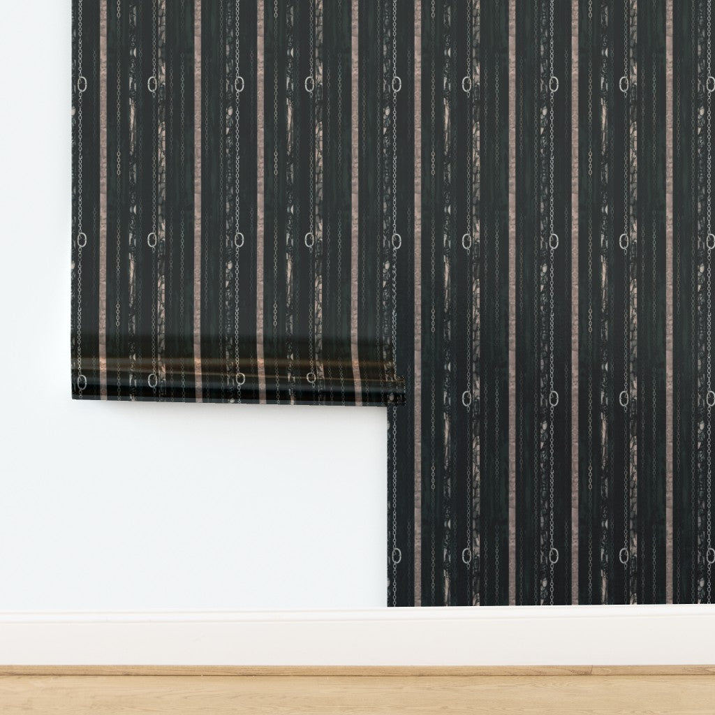 A roll of Couture Chains wallpaper featuring a lustrous metallic finish that catches the light.