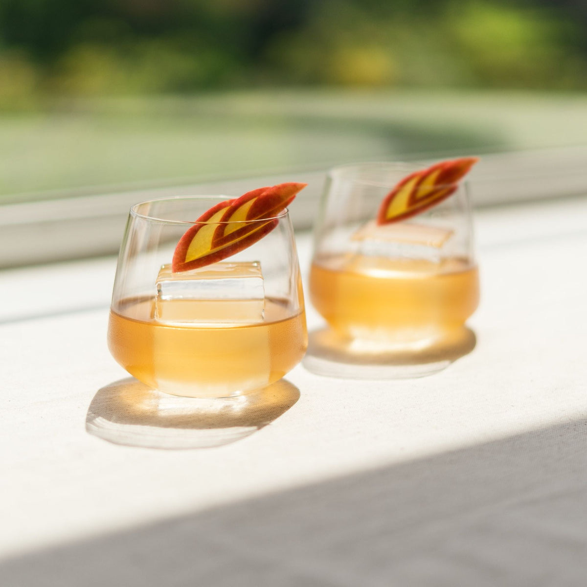 A curated modern home bar setup featuring the Mirage crystal whisky glasses and fine spirits.