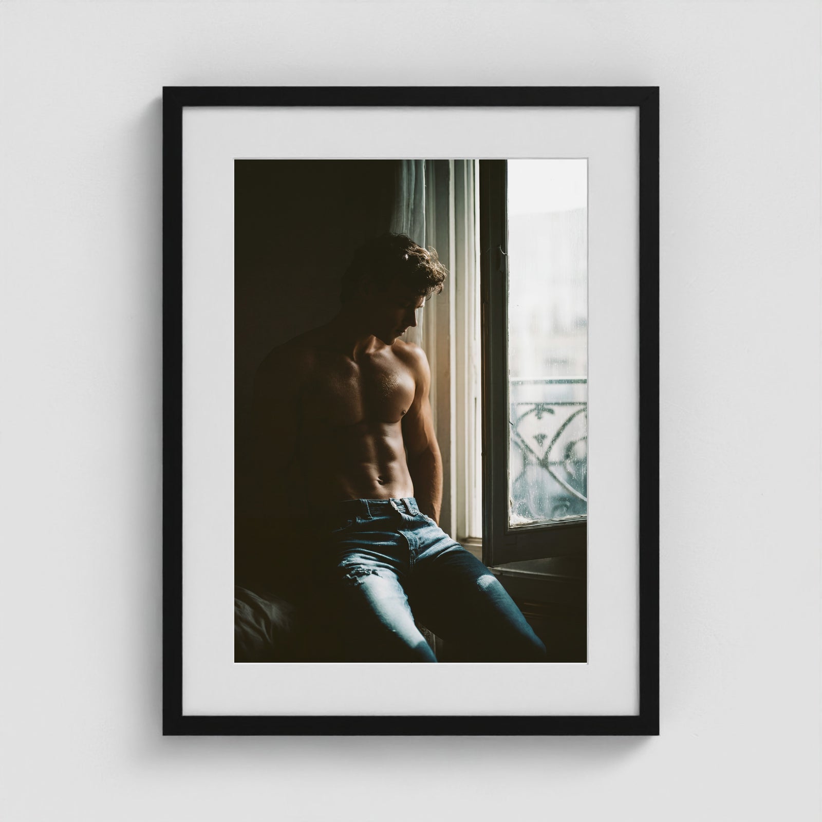 Contemplative window portrait art print in an 18x24 black box frame.