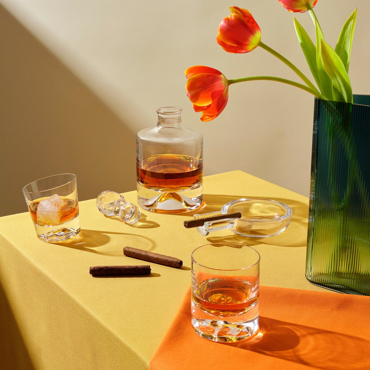 Curated tabletop arrangement with the Egoist cigar ashtray, Shade whisky set, Mist vase, and Memento Mori glass.