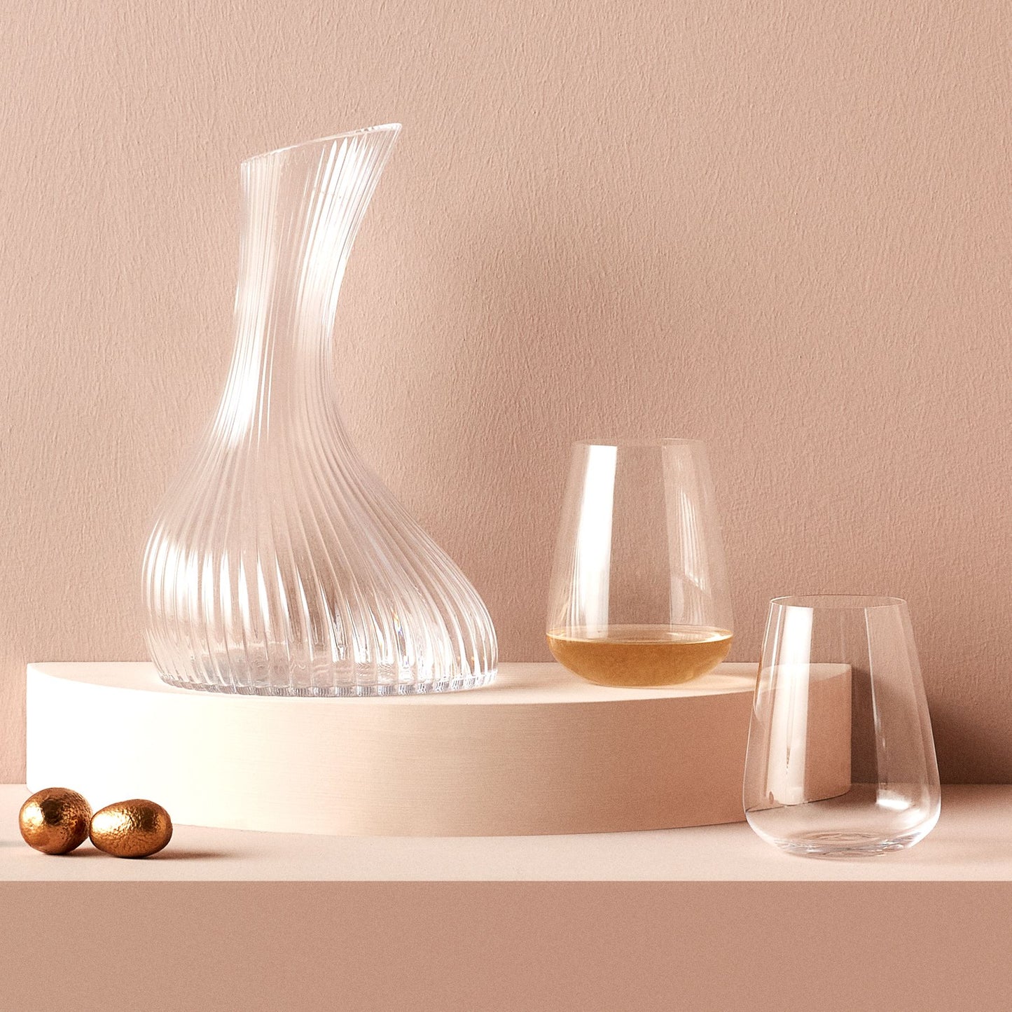 Elegant pairing of a crystal carafe and a Stem Zero water glass on a modern dining surface.