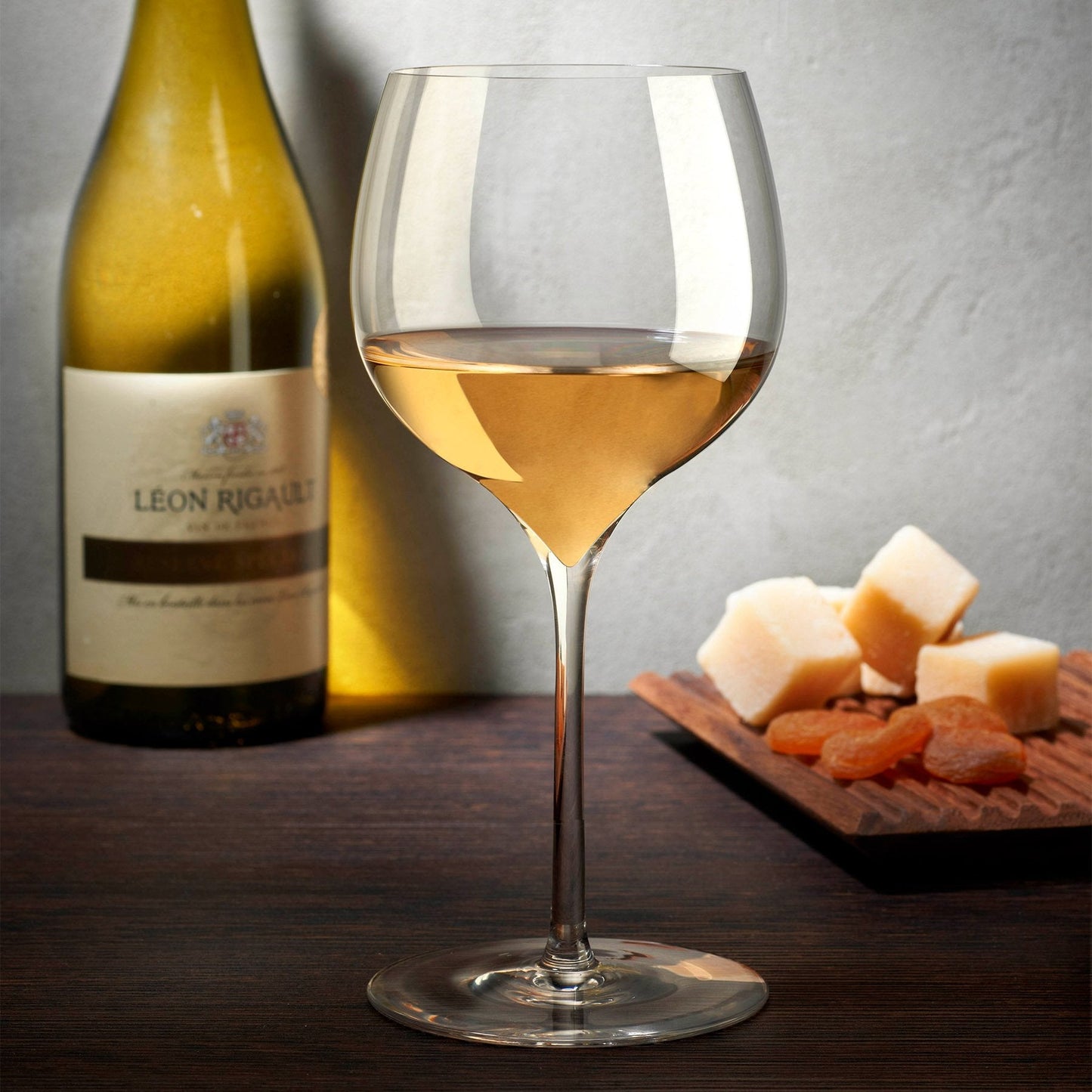 A curated table setting featuring the modern Dimple rich white wine glasses in an elegant dining room setup