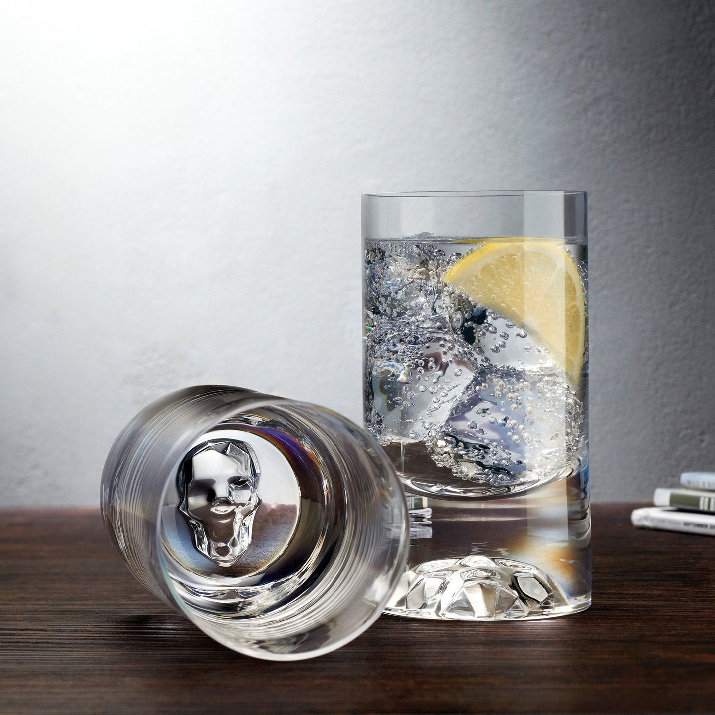 Lifestyle display of the NUDE Glass Shade crystal lowball glasses styled on a modern bar cart.