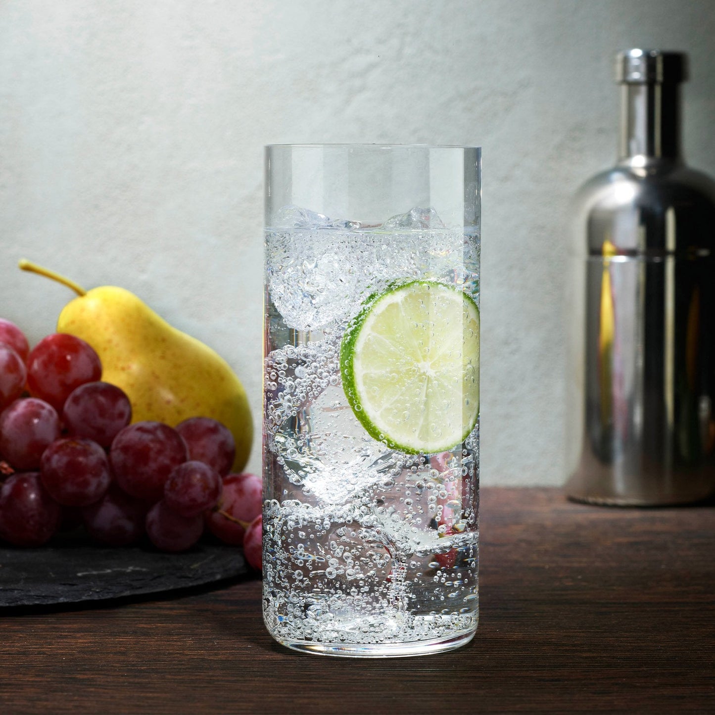 A lifestyle setting featuring the NUDE Finesse Grid crystal glasses arranged on a modern tabletop.