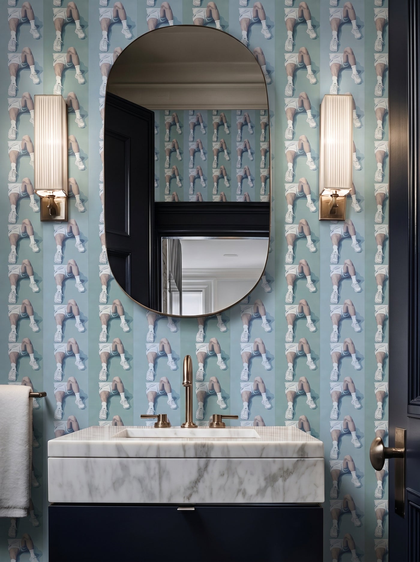 An elegant powder room featuring Court Side striped wallpaper installed on the walls.