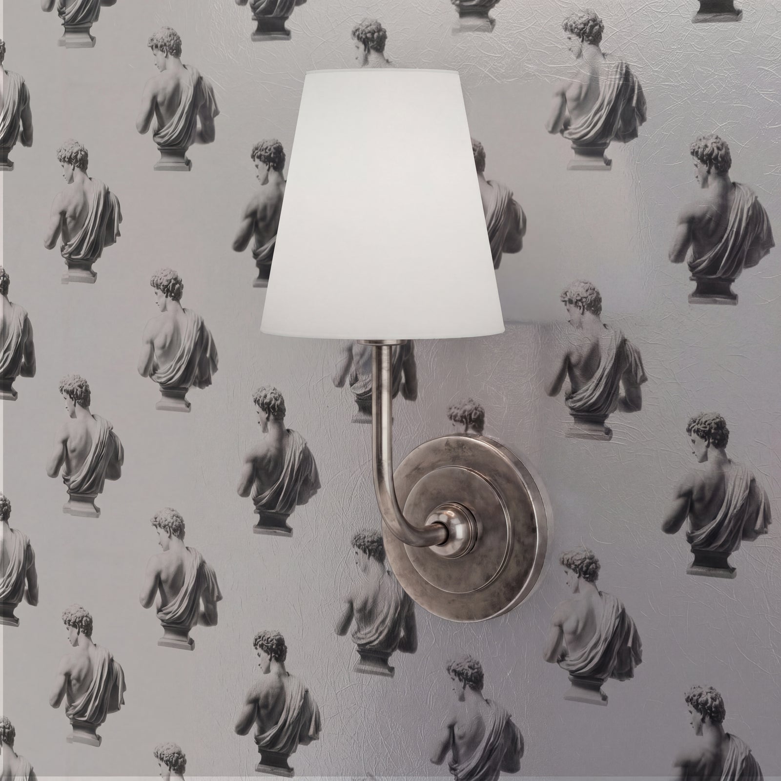 Close-up of the textured classical face pattern on the sculptural Apollo wallpaper