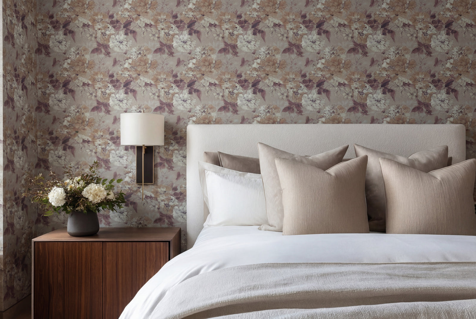 Close-up of painterly watercolor botanical wallpaper on a bedroom feature wall.