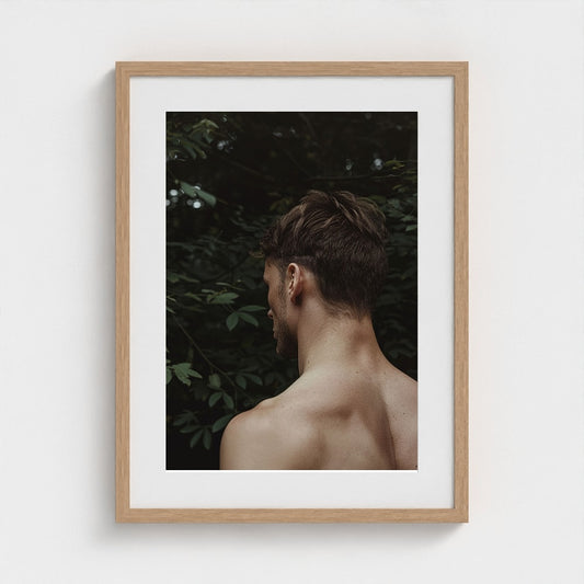Contemplative Male Portrait with Verdant Green Foliage