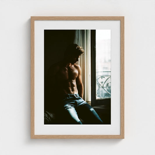 Contemplative Window Portrait in Denim and Soft Light