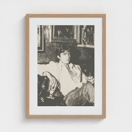 Contemplative Portrait on Leather Sofa in Monochrome