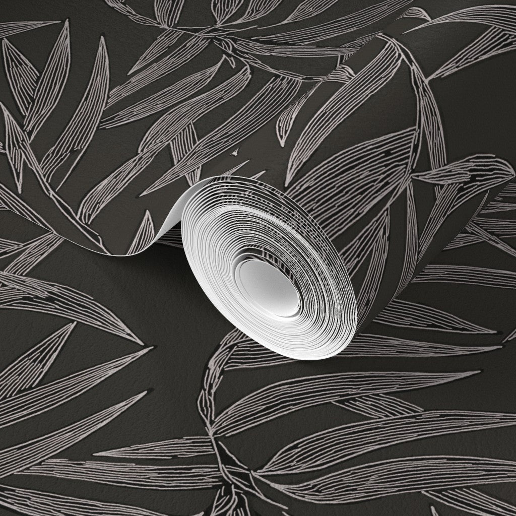 Roll of white paper with a leaf pattern on a black background