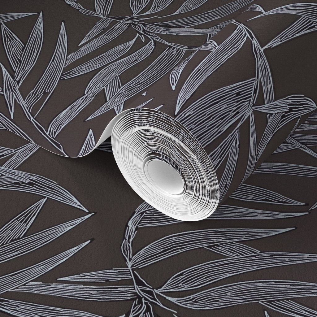 Roll of white paper with leaf pattern on a dark background