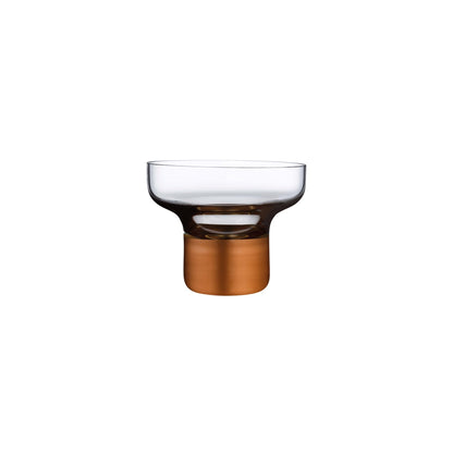 NUDE Glass Contour footed crystal bowl with a high-profile metallic copper base on a clean background.