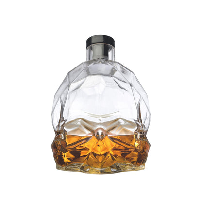 The contemporary NUDE Glass Memento Mori decanter filled with amber whiskey, highlighting its exceptional clarity.
