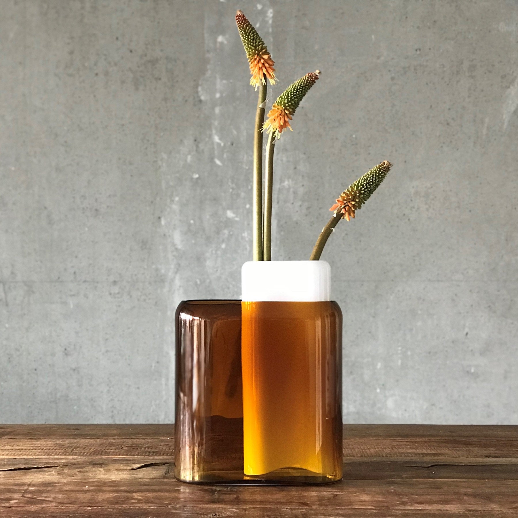 Group of colorful NUDE Glass Layers vases styled together on a tabletop