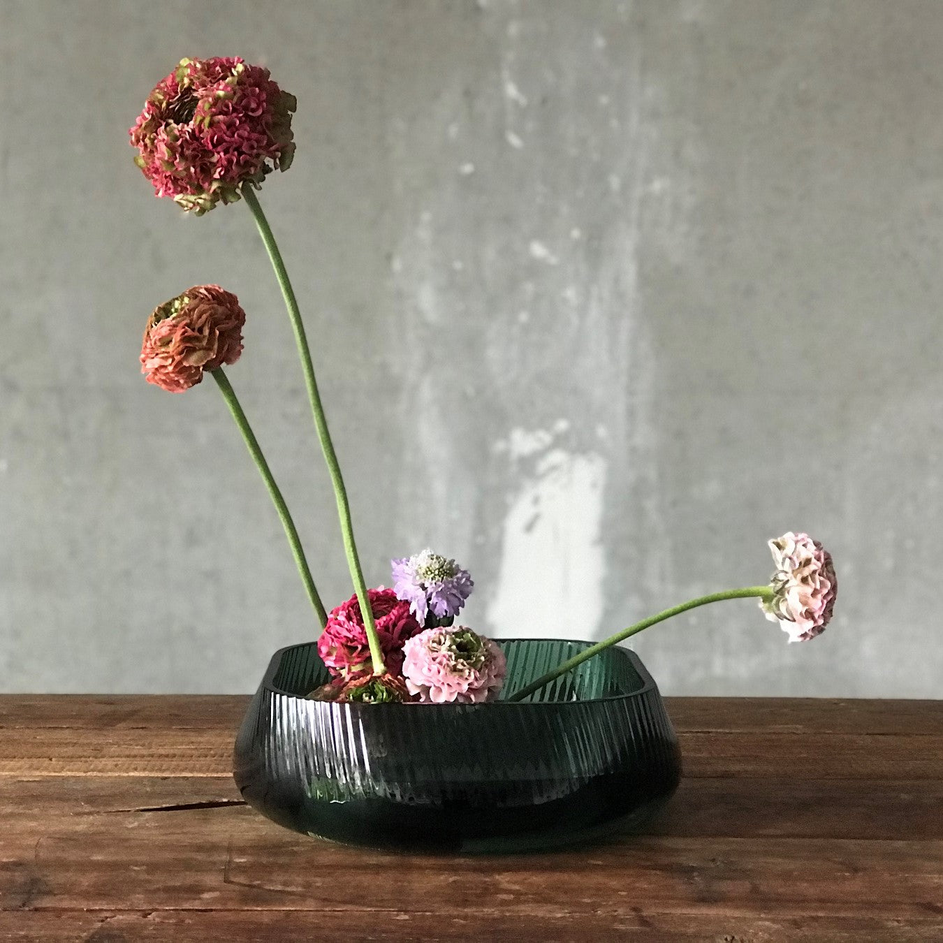 Minimalist side view of the clear NUDE Glass Opti centerpiece bowl showcasing its elegant rippled silhouette