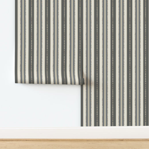 A single rolled bolt of the Rope and Chain Restraint designer wallpaper showing the pattern scale