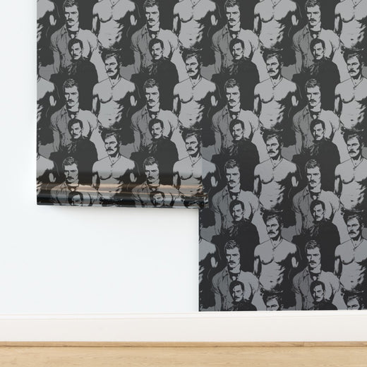 Top-down view of rolled black and white statement wallpaper with portrait graphics
