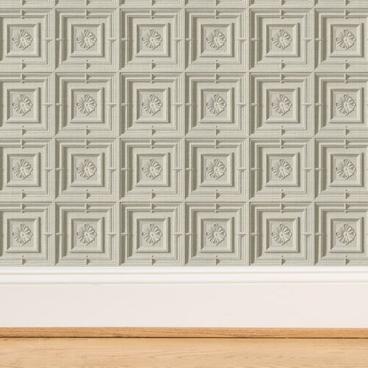 Detailed close-up of the dimensional plasterwork pattern on ivory medallion wallpaper.