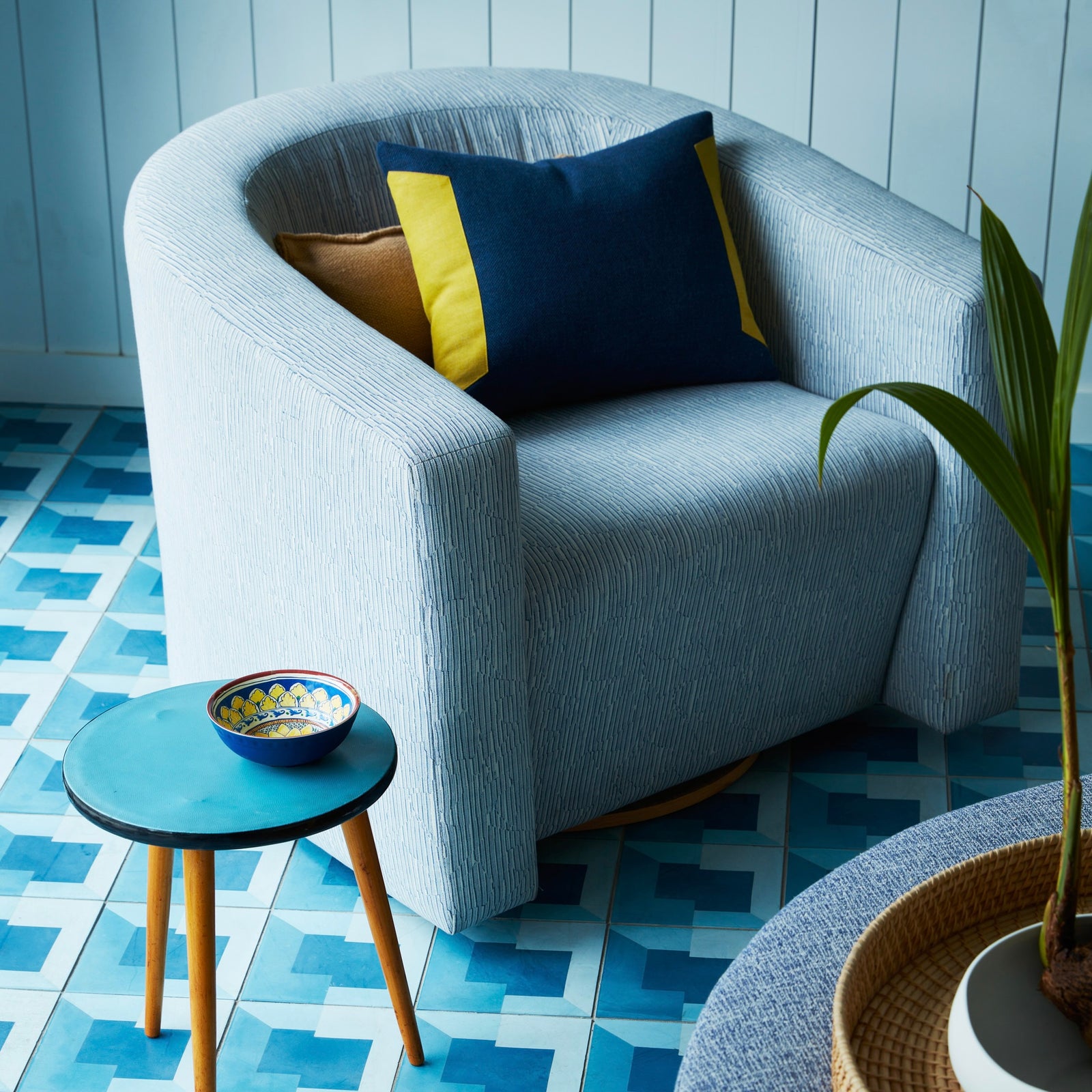 Detailed view of the tailored seating upholstery and refined base of the contemporary lounge chair.