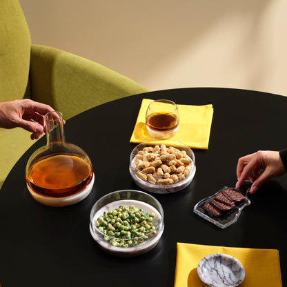 A curated collection of modernist glassware, including the chill bowl, carafe, and tumblers with marble bases.
