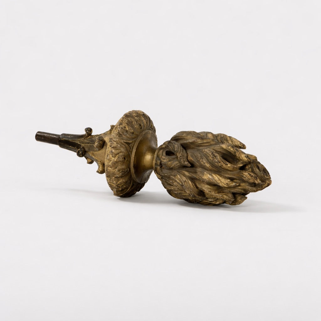Bronze acorn-shaped objects on a white background