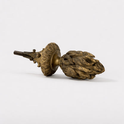 Bronze acorn-shaped objects on a white background