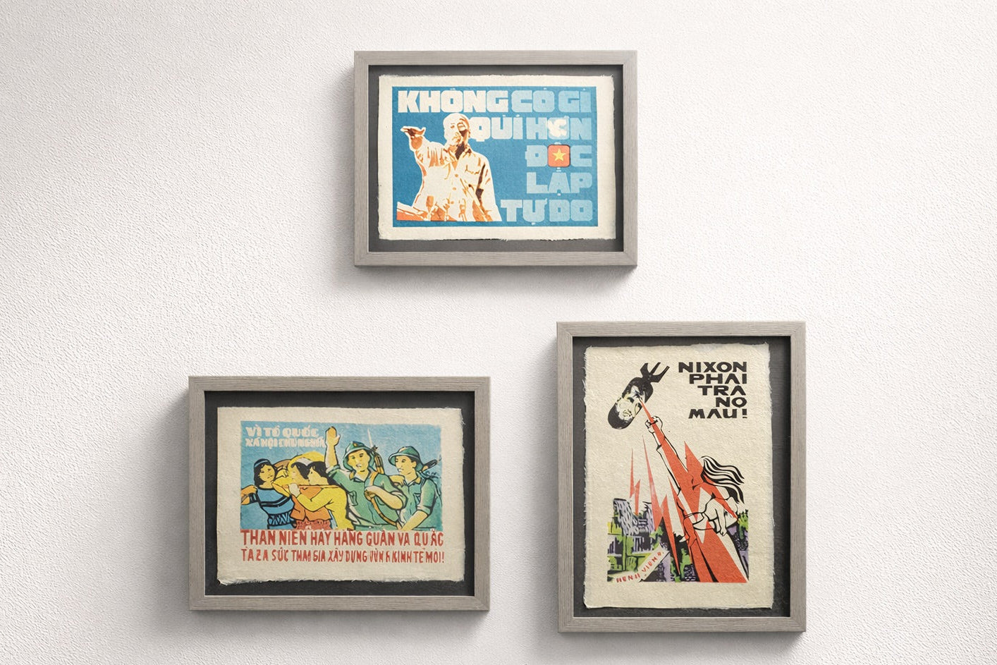 Three framed posters on a white wall with text and images.