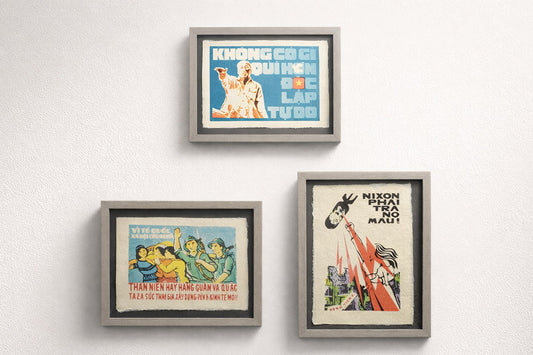 Three framed posters on a white wall with text and images.