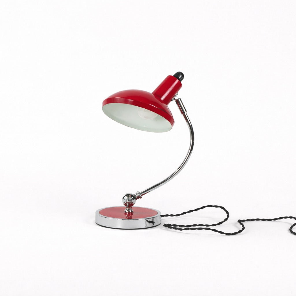 Red desk lamp on a white background