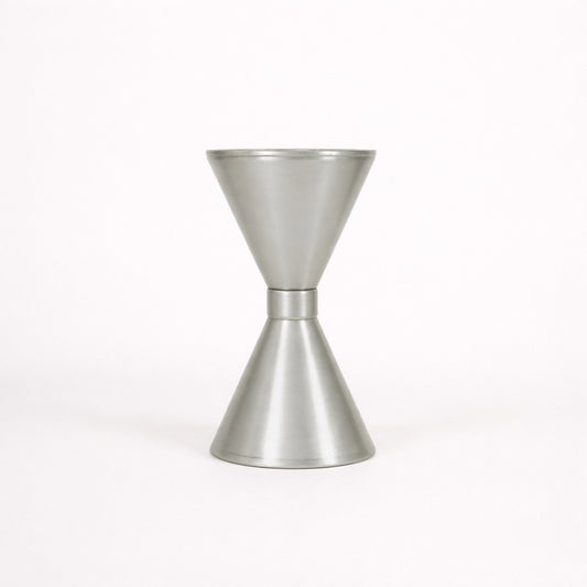 Metallic cocktail jigger on a white background