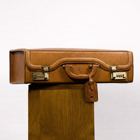 Brown leather briefcase on a wooden stand against a white background