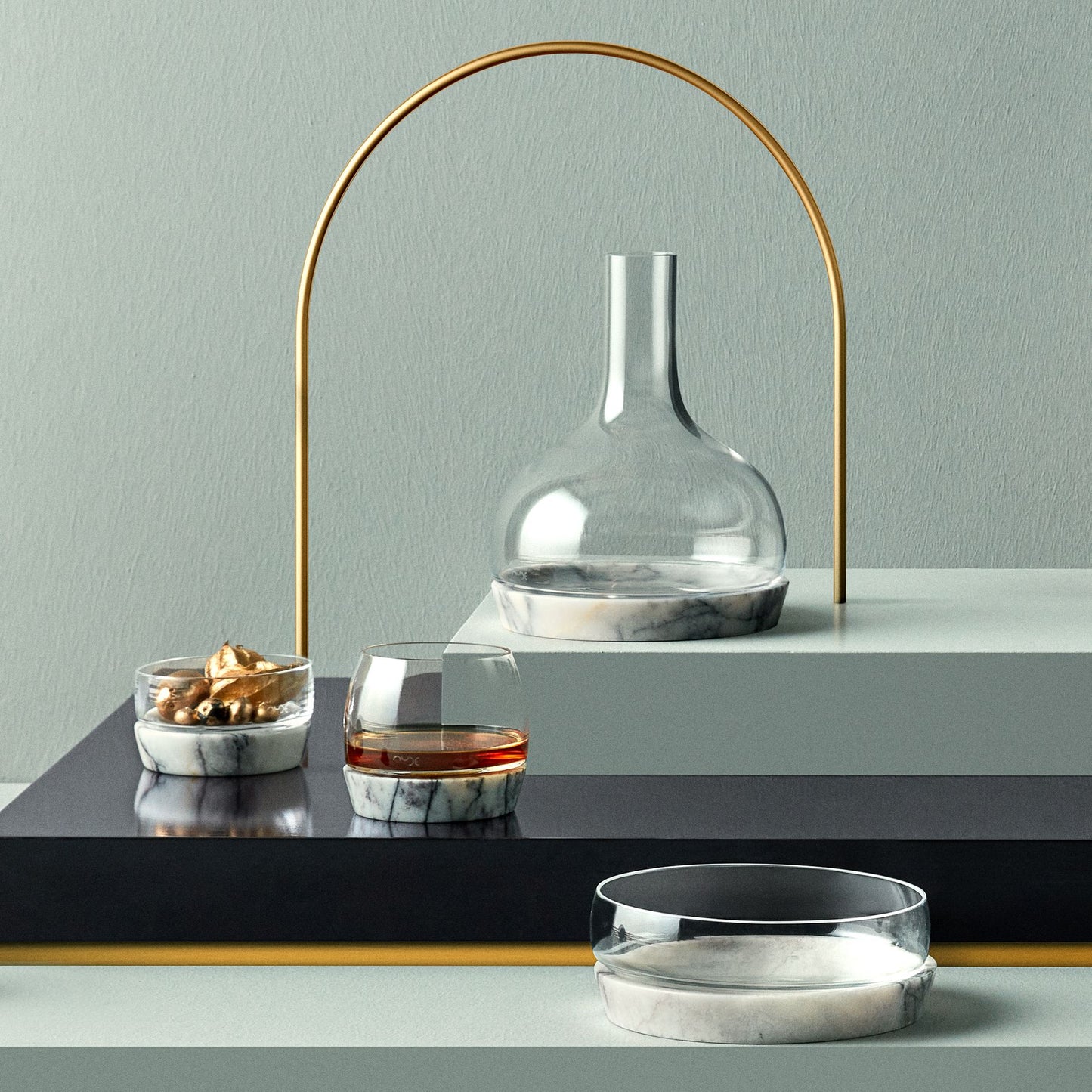Sophisticated bar cart presentation showcasing the entire NUDE Chill crystal and marble collection.