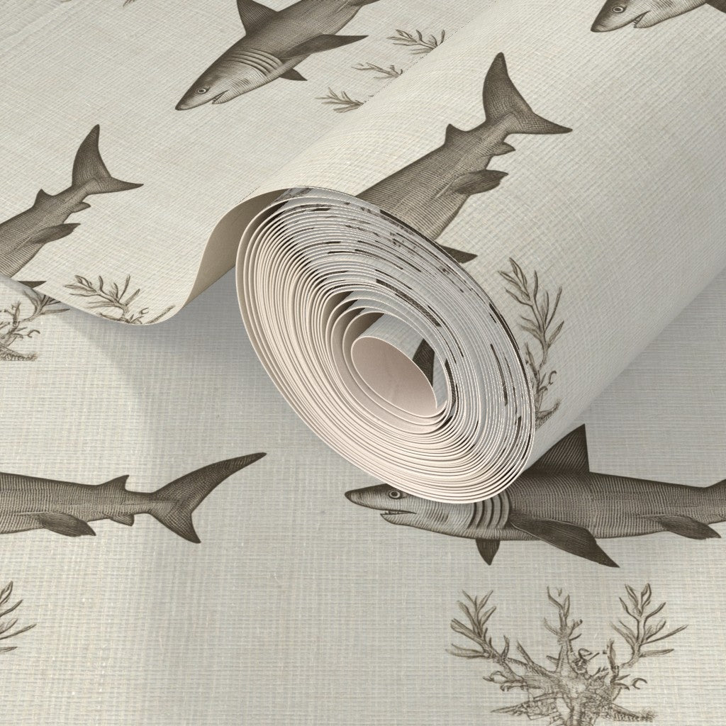Detail of the shark silhouette design on natural woven grasscloth wallpaper showing organic texture.
