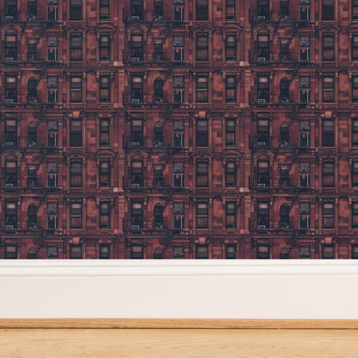 Close-up of Waverly Place oxblood red grasscloth wallpaper with organic woven texture
