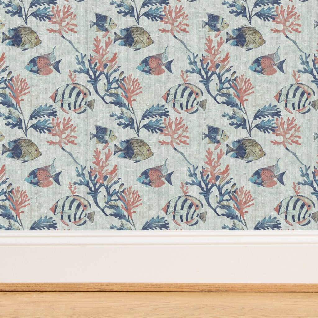 Close-up of the woven texture of light blue grass cloth wallpaper with fish pattern.