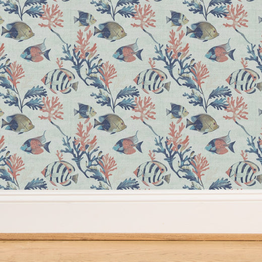 Close-up of the woven texture of light blue grass cloth wallpaper with fish pattern.