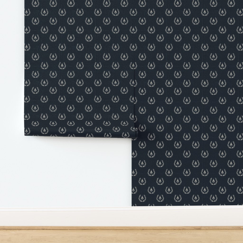 Sailing Crest nautical motif printed on textured, woven natural fiber grasscloth wallpaper.