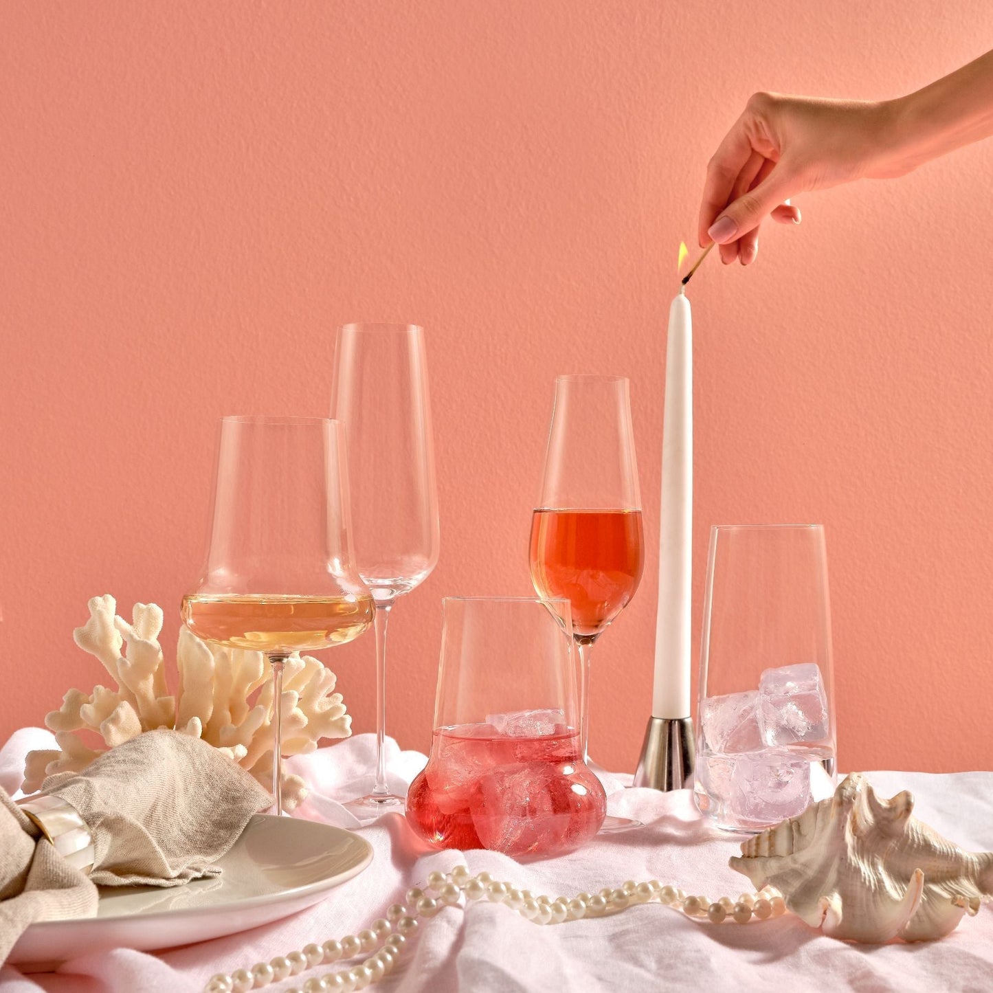 A stylish arrangement of diverse NUDE crystal stemware and champagne flutes on a modern tabletop.