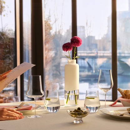 Stunning dining table setting showcasing an assortment of NUDE Ghost Zero crystal glasses and a decorative bowl.