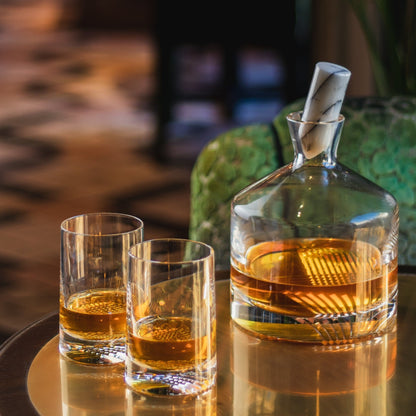 The Alba lead-free crystal whisky decanter filled with rich amber liquor on a wood surface