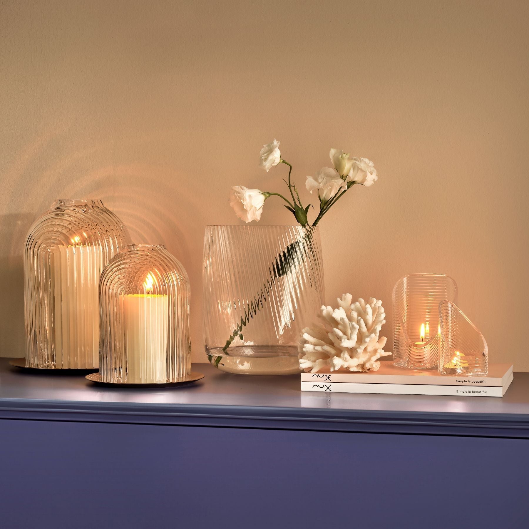 Sophisticated lifestyle vignette featuring the Opti crystal vase alongside modern glass candleholders.