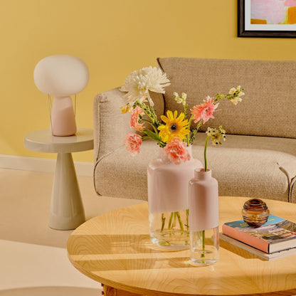 A collection of NUDE glassware including small and medium Magnolia vases styled with modern glass containers.