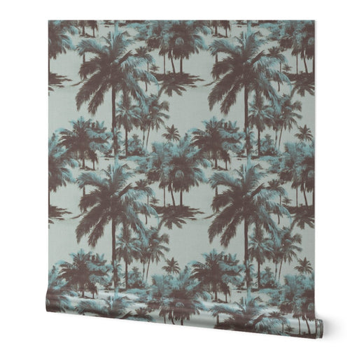 Roll of pearlescent metallic St. Croix palms wallpaper leaning against a wall.