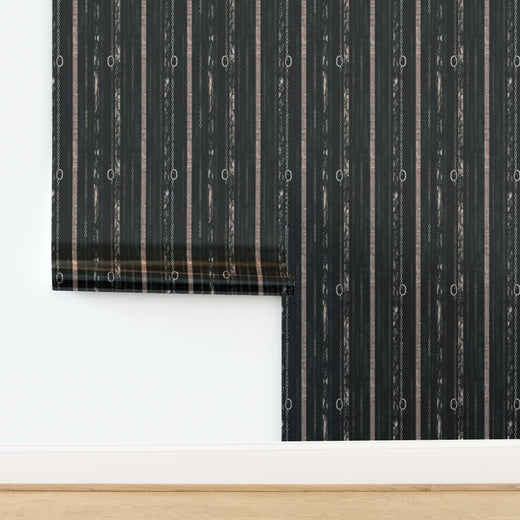 A roll of Couture Chains wallpaper featuring a lustrous metallic finish that catches the light.