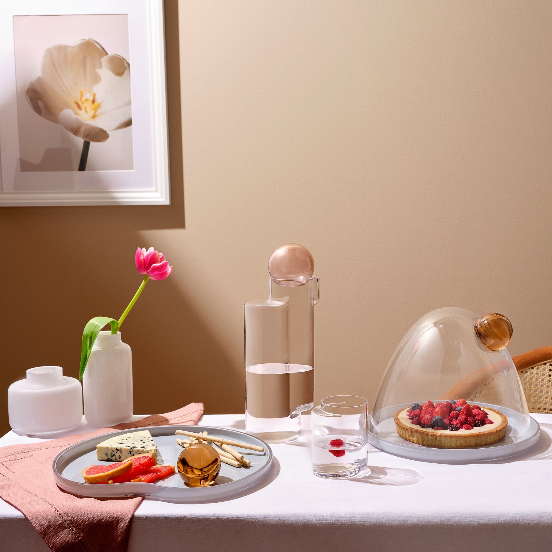 Curated tabletop display featuring NUDE Glass vases alongside modern glassware and tableware.
